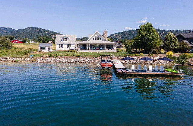 Riverfront custom home with private dock, hot tub, firepit, game room, grill, AC