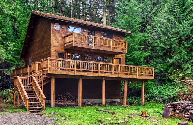 Rustic cabin with wraparound deck and wood stove in a tranquil location