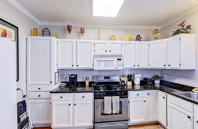 Spacious home with yard, deck, W/D, on-site parking & central AC