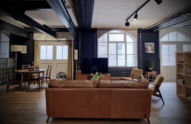 Spacious studio apartment with 20th Century Modern design in an industrial space