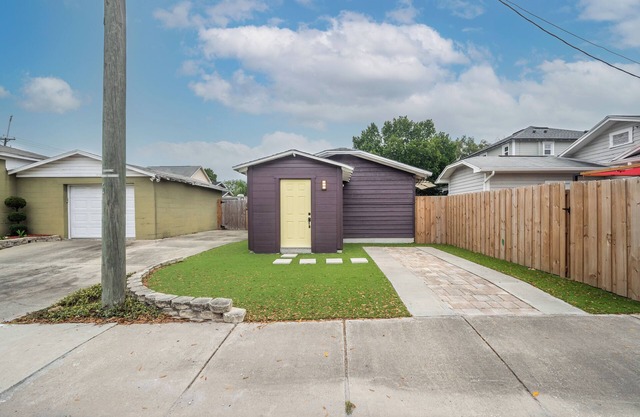 Stand alone studio with private driveway and fenced in backyard.