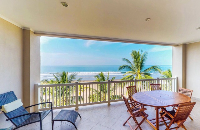 Stunning beachfront condo with WiFi, shared pool, & sweeping ocean views