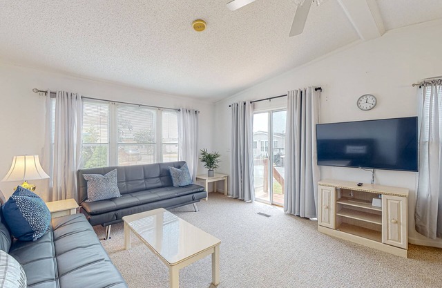 Sunny coastal home with private patio, on-site pool, central AC, & W/D
