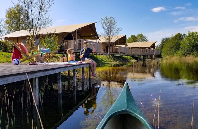 Tents with kitchen and bathroom near a pond