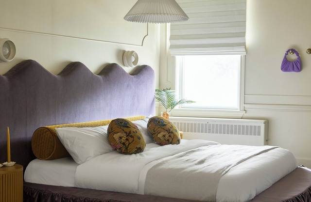 This neutral flat packs a punch with a unique and interesting feature—a round king size bed!