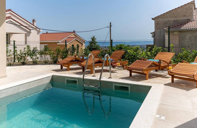 Vacation home with heated pool with covered terrace, stylish interior.