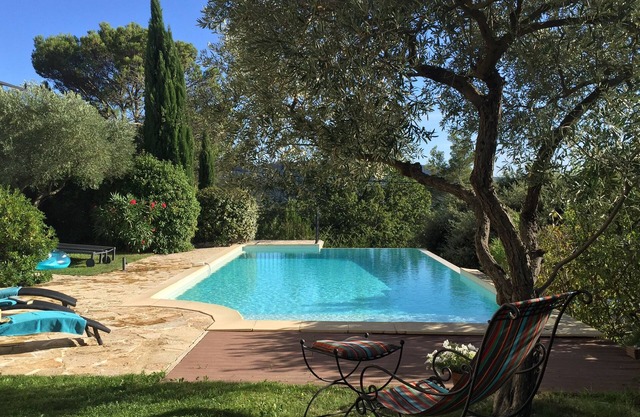 Villa with outdoor kitchen with pizza oven and large heated pool.