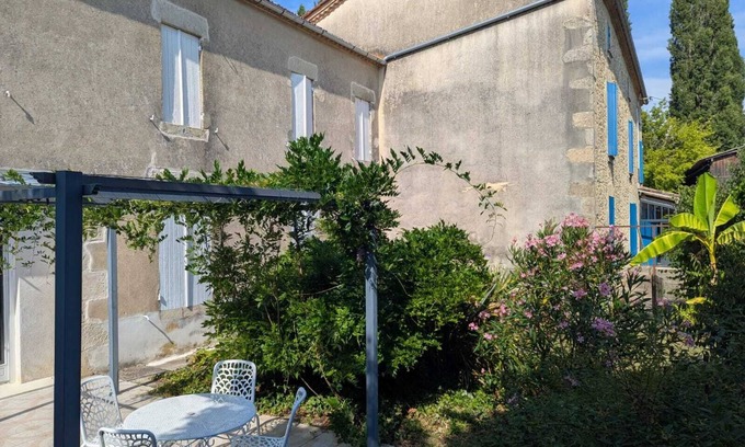 Loubens House | A peaceful interlude in a lush, flower-filled garden.