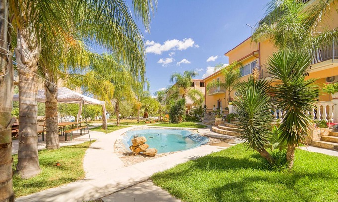 Partinico Apartment | A spacious apartment with a bathing area in the garden awaits you.