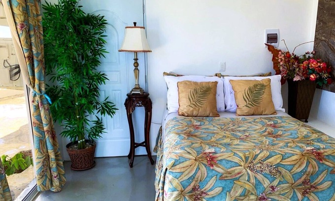 Cabrera Hotel | Adorable tropical room with a stunning balcony, pool, fire pit, gardens, & more!