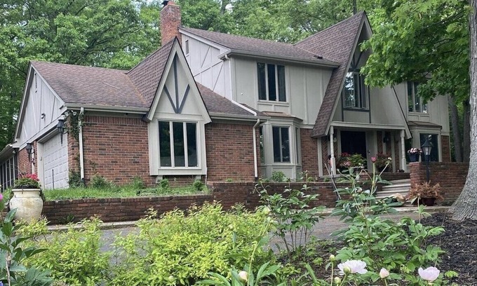 Farmington Hills House | Beautiful English Farmhouse Tudor, situated on a lush hillside acre.