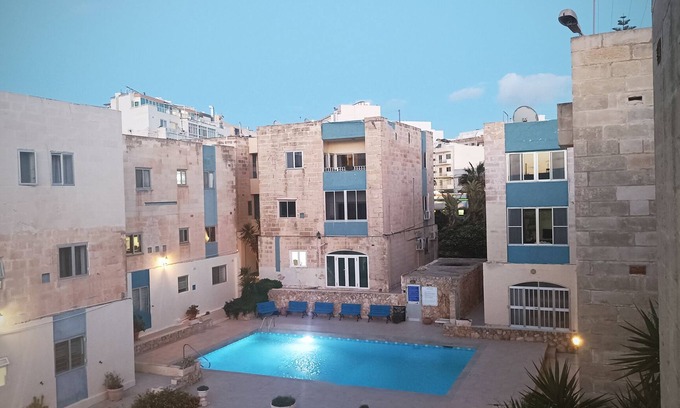 Qawra Apartment | Beautiful Flat with Swimming pool and Seaview, nestled in an amazing garden