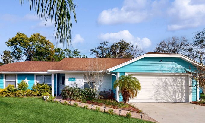 Spring Hill House | Bright & charming beach retreat with large lanai, firepit, & fireplace - dogs ok