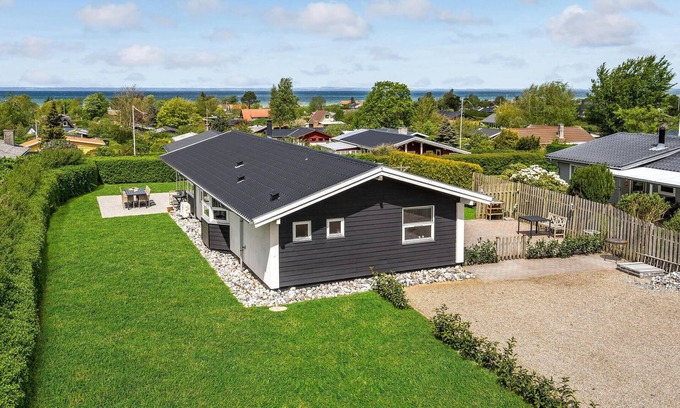 Skastrup Strand House | Catch a view of the sea from the terrace of this pleasant and bright vacation home.