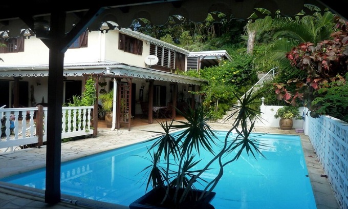 Les Abymes Apartment | Charming studio in a tropical garden. with swimming pool, free wifi and parking.