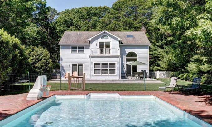 Wainscott Woods House | Classic Summer home with heated pool, hot tub, deck, outdoor seating,...