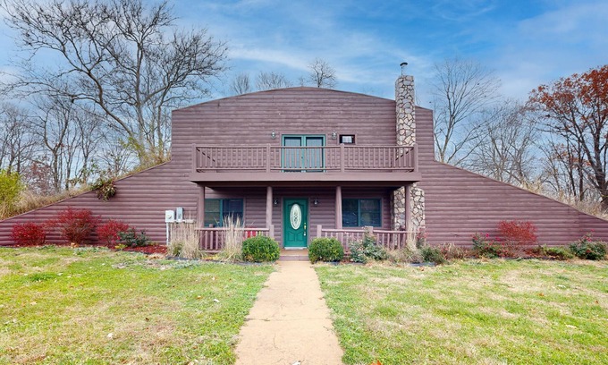 Banner House | Cozy Hobbit House inspired home with large balcony and front porch