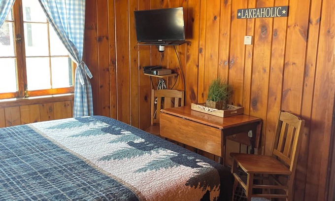 Itasca County Resort | Cozy queen bed in main Resort Lodge