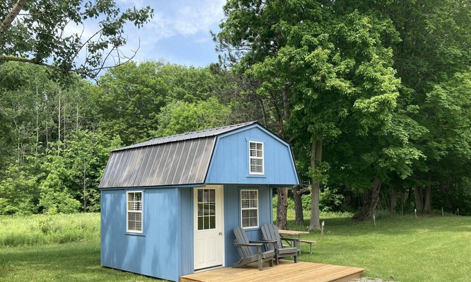 Front of Yonge RV Rental | Cozy solar bunkie cabin located happy green acres campground