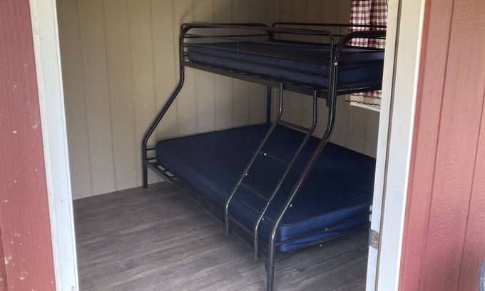 Front of Yonge RV Rental | Cozy solar Bunkie cabin located happy green acres campground