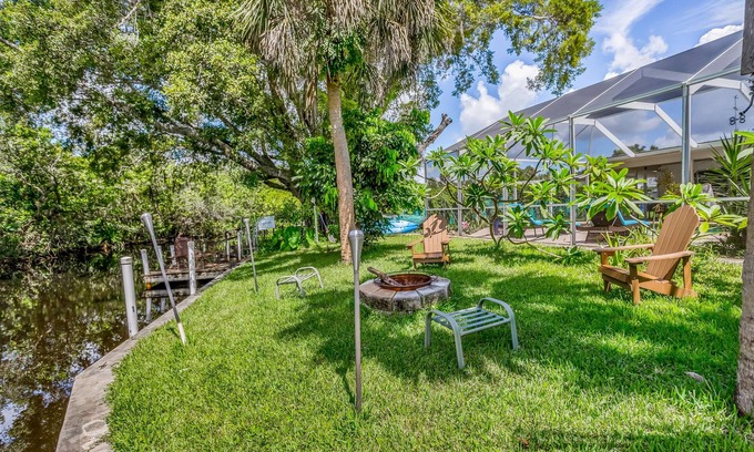 Fort Myers House | Creekside retreat with screened pool, patio, grill, firepit, canoe + kayak, & AC