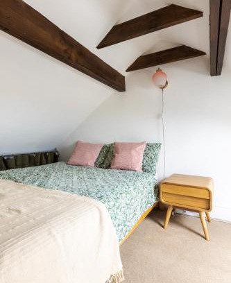 Hertford House | En-suite with double bed on mezzanine and desk in family home