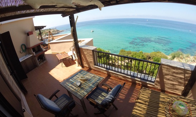 Alghero Apartment | Exclusive penthouse overlooking the sea . with deserted beach under the house.