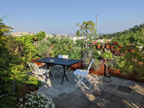Zizkov House | Guestrooms, rooftop with garden, spacious living room, character and fireplace