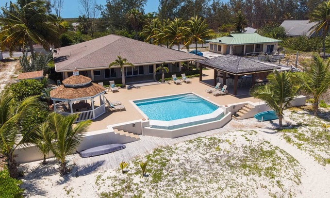 Rokers Point House | Hart House, vast patio with hot tub, heated pool & outdoor bar on Flamingo Bay