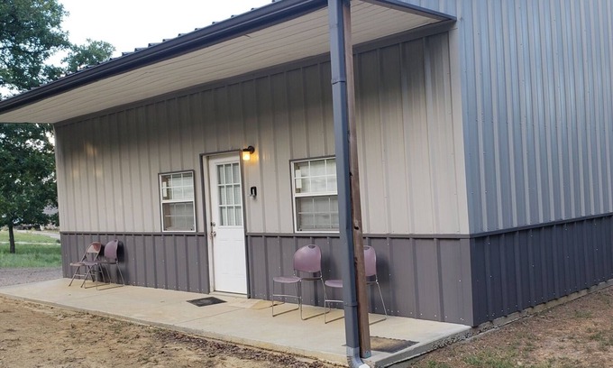 Sulphur House | Henson 2: Rustic 2 Bedroom Cabin surrounded by trees.