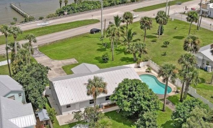 Micco House | Indian River Waterfront Home with private dock, heated pool, fenced back yard