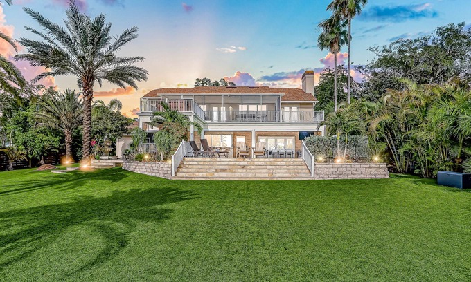 Carrollwood House | Inviting lakefront home with dock, kayaks, hot tub, pool, firepit, & W/D