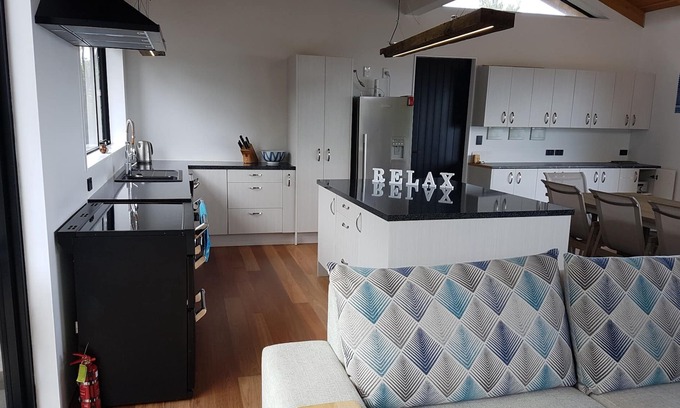 Kawau Island House | Kitchen and entertainment area with views and 3 pods for sleeping all separate
