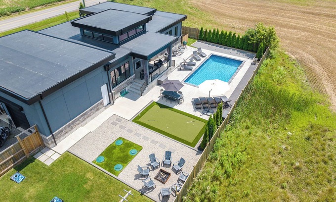 Niagara Falls House | La dolce Vita Villa back yard Oasis inground pool putting green bocci firepit