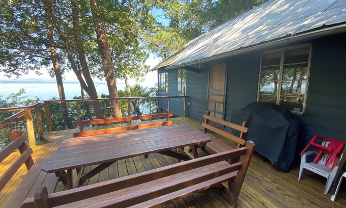 Charlotte Cabin | Lake Champlain camp, spacious deck, sunset & mountain views, beach and dock