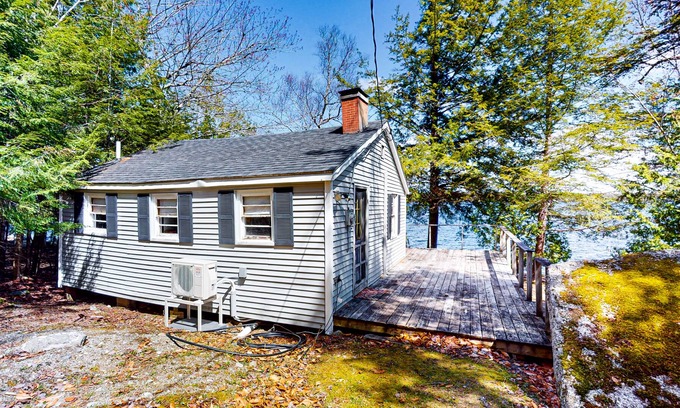 Otis Apartment | Lakefront cabin with deck, grill, screened porch, & firepit - dog-friendly