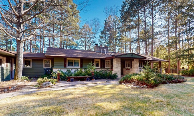 Lac du Flambeau House | Lakefront house with private covered hot tub, dock, wood fireplace, & firepit