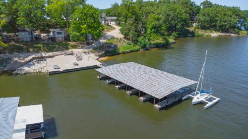 Lake Ozark House | Lakeshore Fishing Cabin 5, dock, boat slip and firepit area