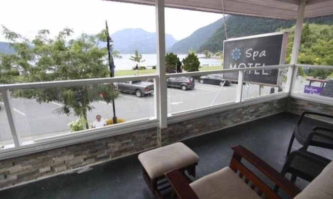 Harrison Hot Springs Cabin | lakeside bedroom and a living area with stunning views of Harrison Lakennn