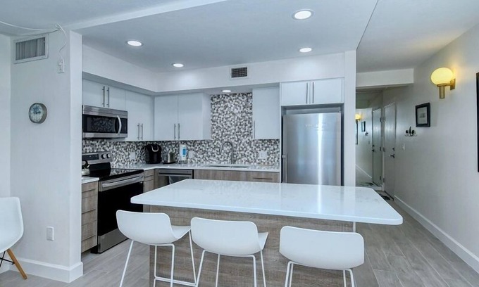 Longboat Key Condo | LaPlaya 101A - Step out to the beach from your screened lanai. Light and bright end unit.