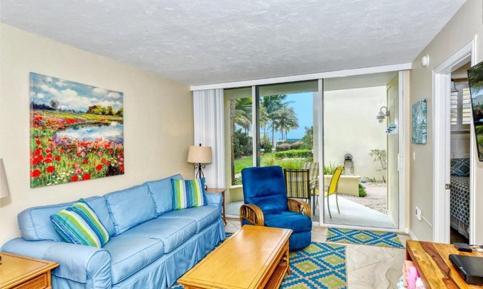 Longboat Key Apartment | LaPlaya 101E-Relax on your private lanai under the palms!