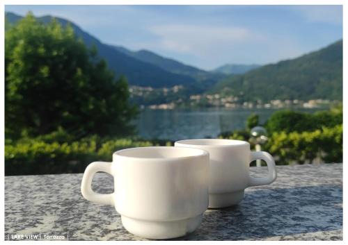 Cima Apartment | LFSUITE LuganoLake Terrazza Spiaggia privata Parking WI-FI Netflix