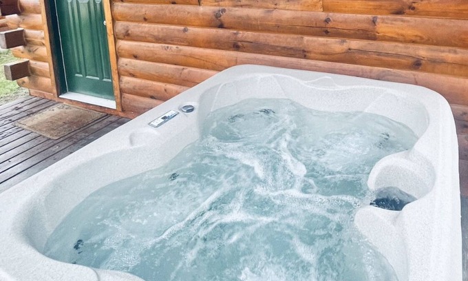 Thompsonville Cabin | Log Cabin with Hot Tub 2 Miles from Crystal Mountain!