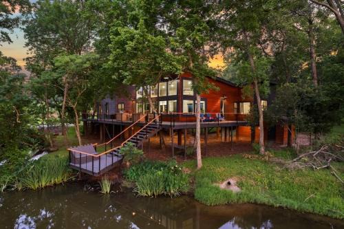 Montgomery House | LUX Treehouse on Private Lake next to Lake Conroe with Game room, Paddleboards, Lake Views, and more!
