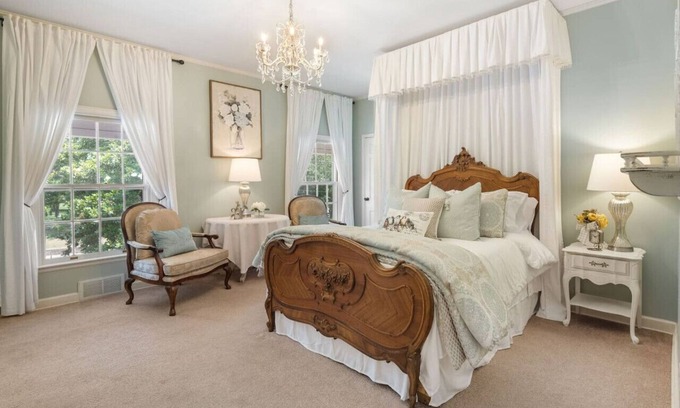 Fort Smith House | Magnolia suite with queen size bed, sitting area, soaking tub and smart tv