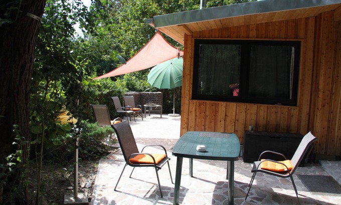 Friedrichroda House | Modernly furnished bungalow with fireplace, surrounded by greenery.
