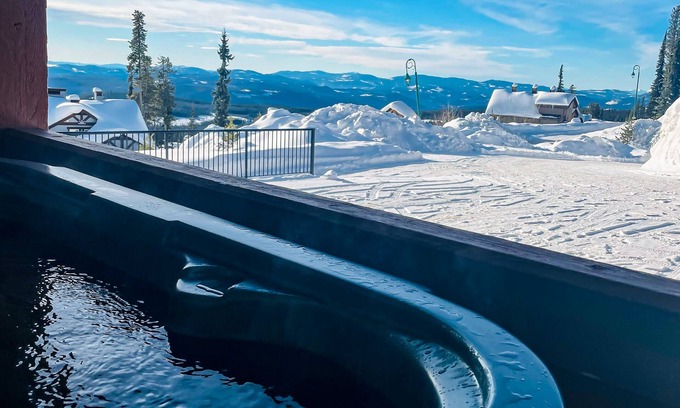 Big White Ski Resort Condo | Mountain view ski-in/out home with a hot tub & fireplace - walk to village