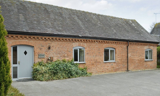 Denstone Cottage | One of two barn conversions with exposed beams and trusses.