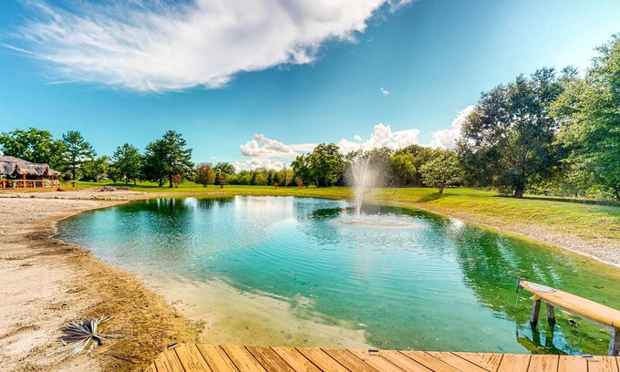 Waller House | Resort-Style Oasis with Swimming Pond, Beach, Tropical Hut & Bar