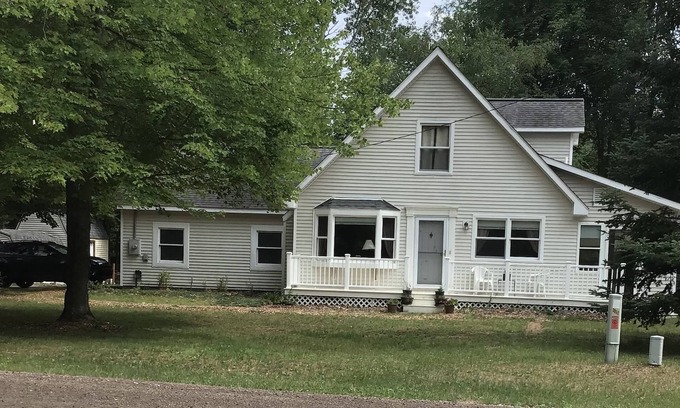 Lake House | Roomy home with spacious fenced in backyard and fire pit.
